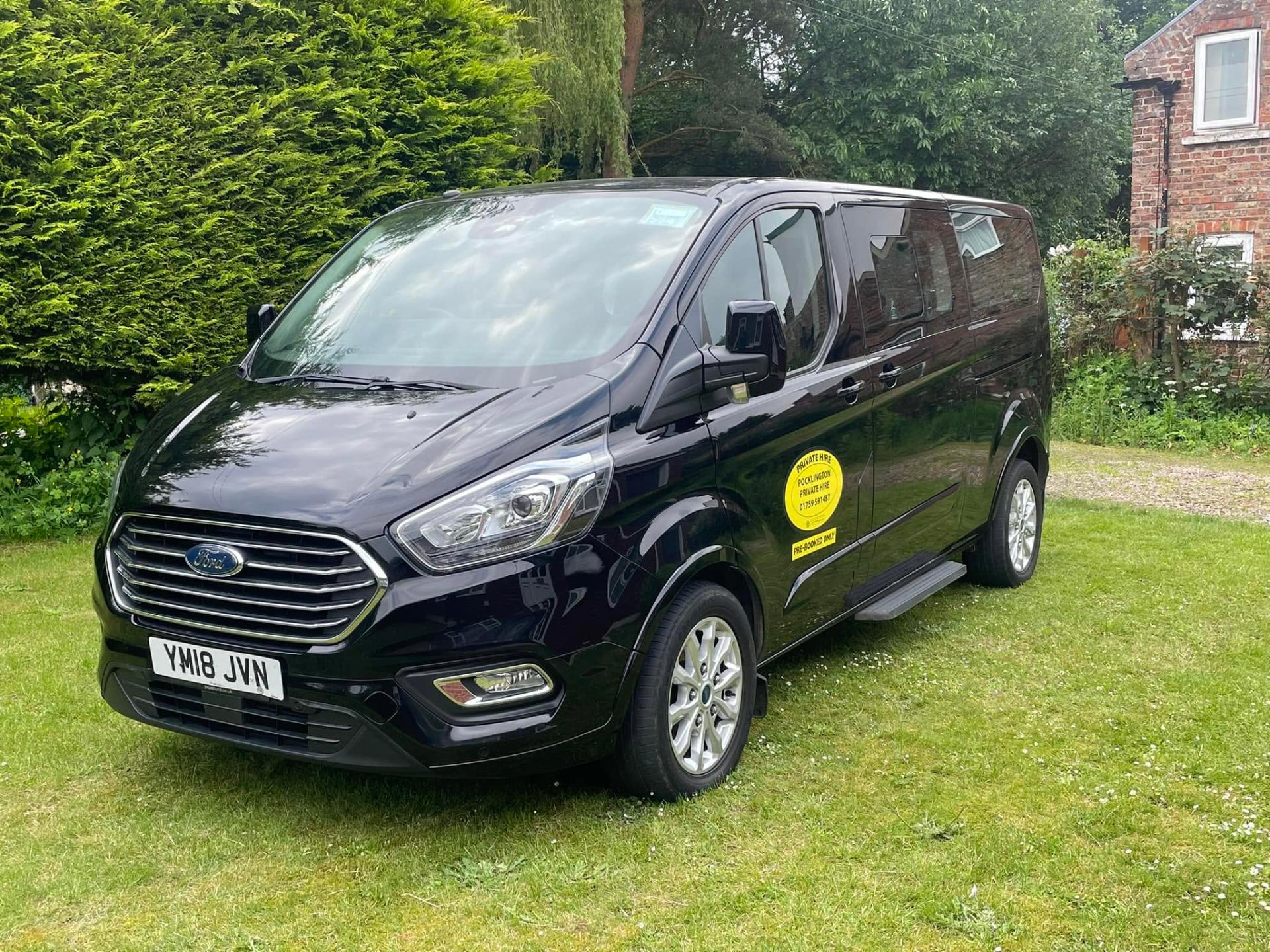 Pocklington Private Hire 8-seater Ford Tourneo parked in a Yorkshire garden